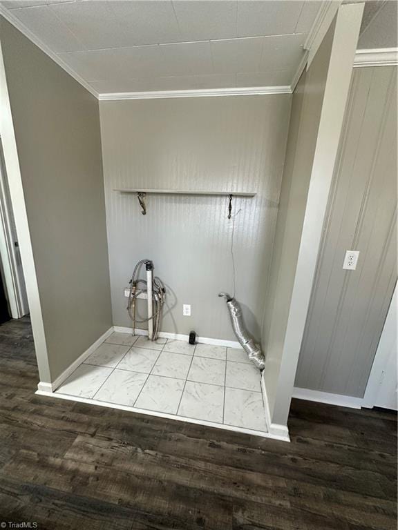 clothes washing area featuring ornamental molding and hardwood / wood-style floors