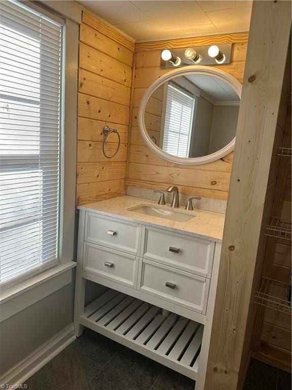 bathroom with vanity, tile patterned floors, and wood walls