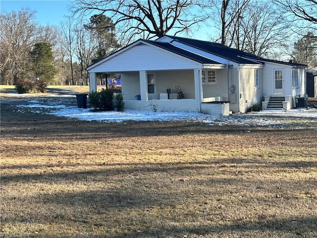 view of front of property with a porch, a front lawn, and central air condition unit