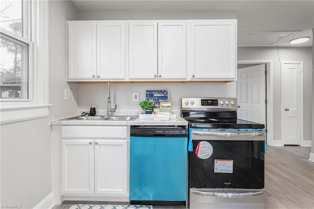 kitchen with dishwasher, light countertops, electric stove, wood finished floors, and white cabinets