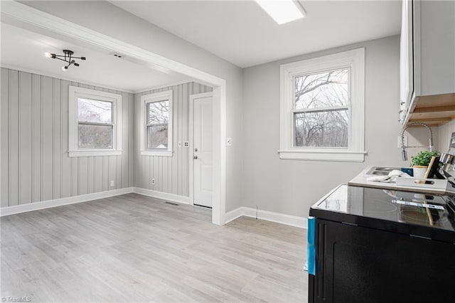 foyer with baseboards and light wood-type flooring