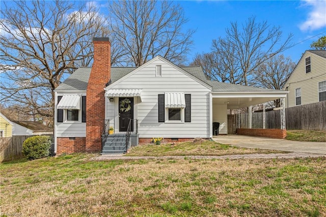 view of front of property with fence, concrete driveway, a front yard, crawl space, and an attached carport