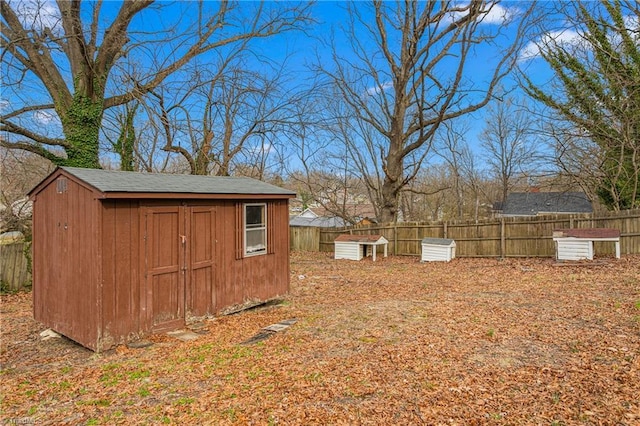 view of yard featuring a fenced backyard, a storage shed, and an outdoor structure