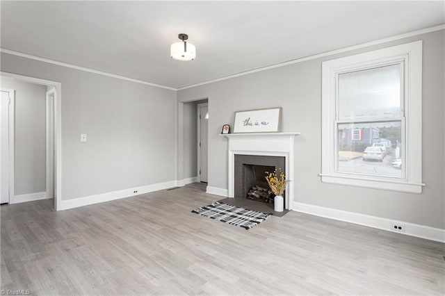 unfurnished living room with a fireplace with flush hearth, baseboards, light wood finished floors, and ornamental molding