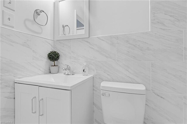 2102 Bothwell St, Greensboro, NC 27401 - bathroom with vanity, tile walls, and toilet