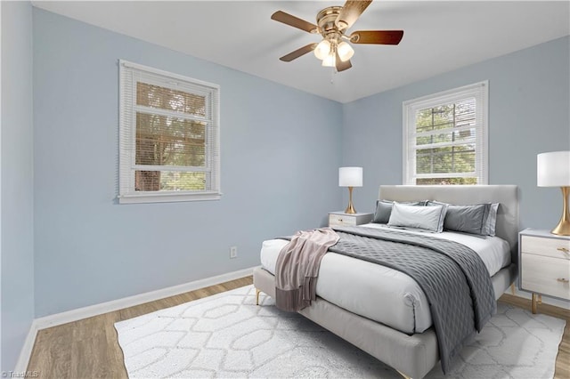 2102 Bothwell St, Greensboro, NC 27401 - bedroom with wood finished floors, baseboards, and a ceiling fan