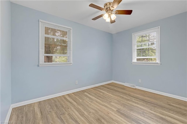 2102 Bothwell St, Greensboro, NC 27401 - unfurnished room with wood finished floors, baseboards, and ceiling fan