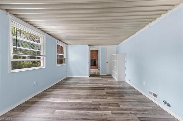 2102 Bothwell St, Greensboro, NC 27401 - unfurnished room featuring plenty of natural light, wood finished floors, a fireplace, and baseboards