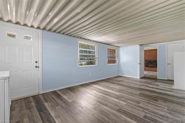2102 Bothwell St, Greensboro, NC 27401 - unfurnished living room featuring wood finished floors, baseboards, and a fireplace
