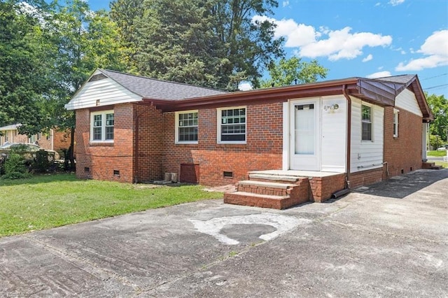 2102 Bothwell St, Greensboro, NC 27401 - view of front of house featuring crawl space, brick siding, a front lawn, and driveway