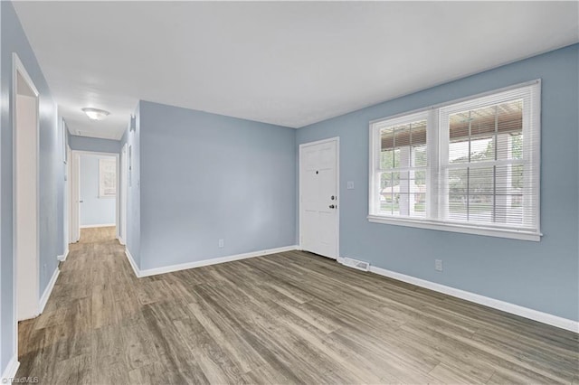 2102 Bothwell St, Greensboro, NC 27401 - unfurnished living room featuring wood finished floors and baseboards