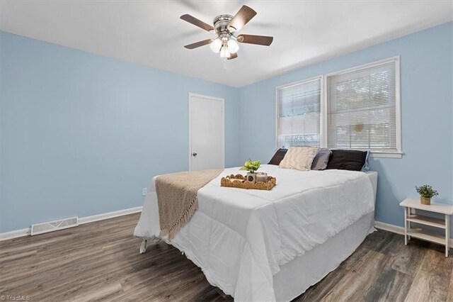 2102 Bothwell St, Greensboro, NC 27401 - bedroom with wood finished floors, baseboards, and a ceiling fan