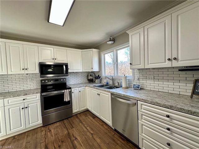 kitchen featuring white cabinets, sink, appliances with stainless steel finishes, and tasteful backsplash