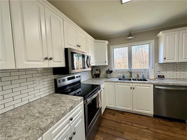 kitchen with tasteful backsplash, sink, white cabinets, and stainless steel appliances