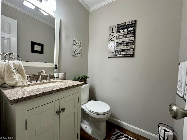 bathroom featuring hardwood / wood-style floors, vanity, toilet, and ornamental molding