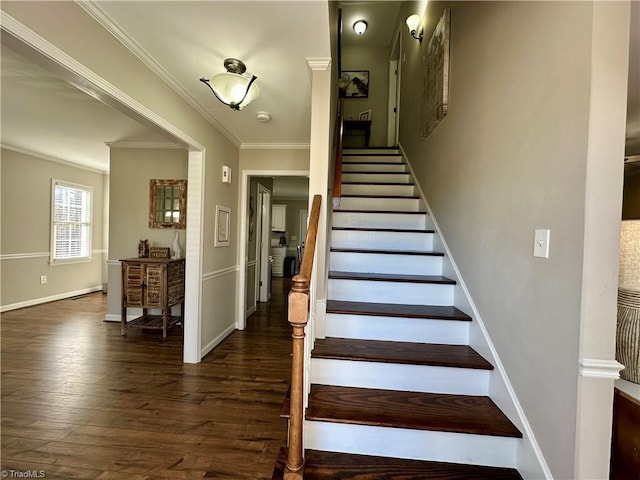 stairway with hardwood / wood-style floors and ornamental molding