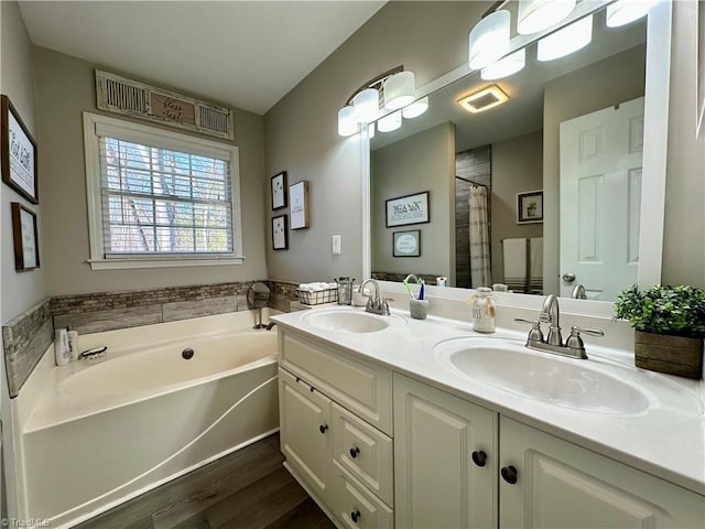 bathroom featuring independent shower and bath, vanity, and wood-type flooring