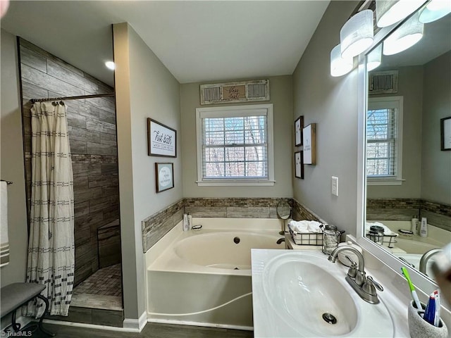 bathroom featuring sink and shower with separate bathtub