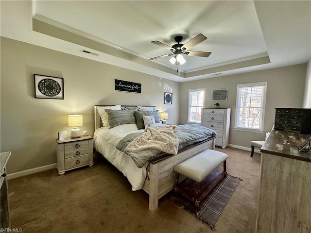 carpeted bedroom with a raised ceiling, ceiling fan, and ornamental molding