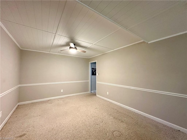 carpeted empty room featuring ceiling fan and ornamental molding