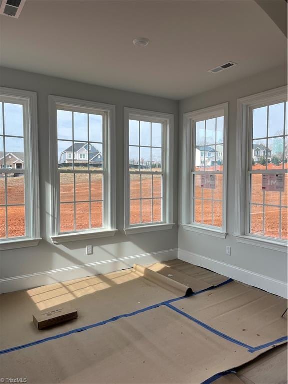 unfurnished sunroom with plenty of natural light