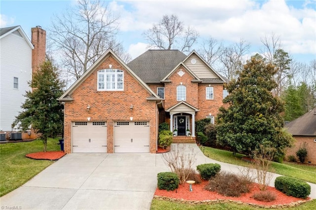 view of front facade with driveway, a shingled roof, an attached garage, a front yard, and brick siding