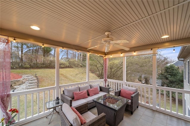 sunroom with a wealth of natural light and a ceiling fan