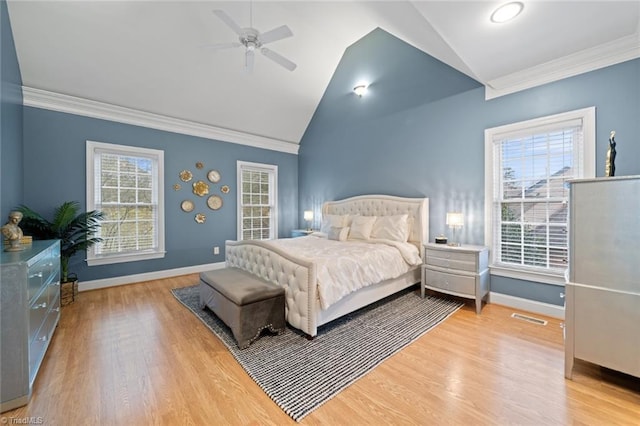 bedroom with visible vents, multiple windows, crown molding, and vaulted ceiling