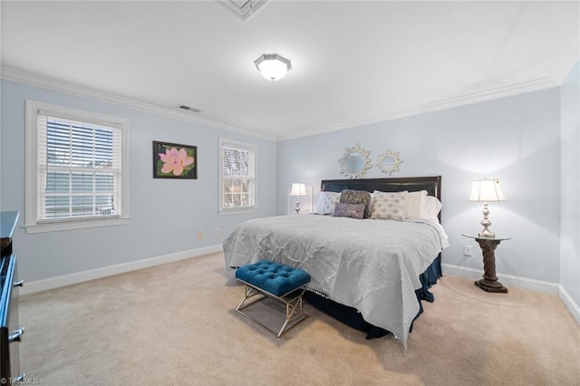 carpeted bedroom featuring visible vents, baseboards, and ornamental molding