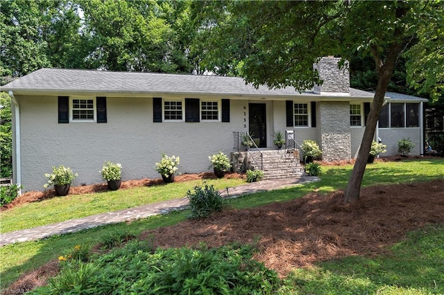4255 Bower Ln, Winston-Salem, NC 27104 - ranch-style home with a chimney, a sunroom, a front lawn, and stucco siding