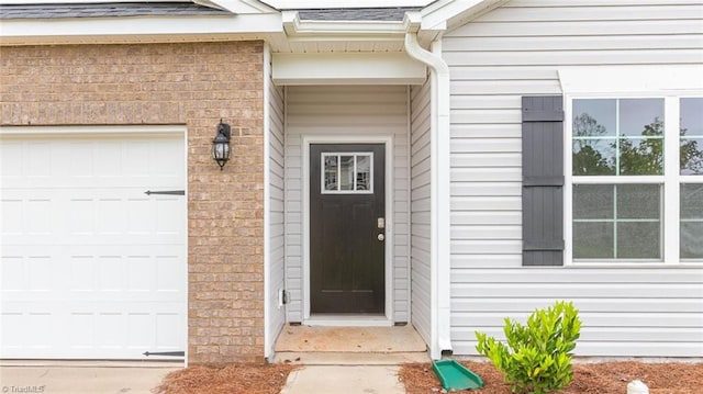 view of exterior entry with a garage