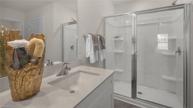 bathroom with vanity and a shower with door