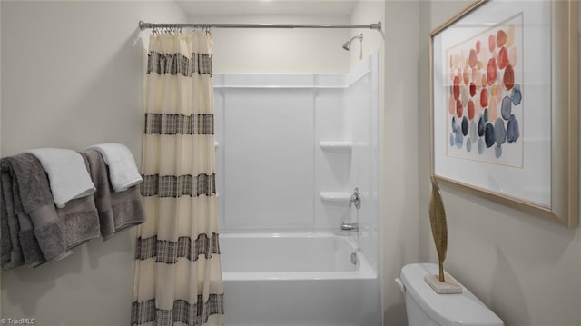 bathroom with shower / bath combo and toilet