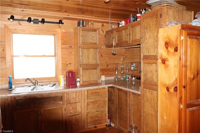 197 Mahogany Ct, Lansing, NC 28643 - kitchen featuring brown cabinetry, wood ceiling, wood walls, and a sink
