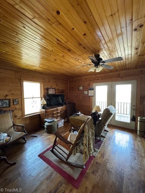 197 Mahogany Ct, Lansing, NC 28643 - living area featuring wooden walls, a healthy amount of sunlight, a ceiling fan, and wood ceiling