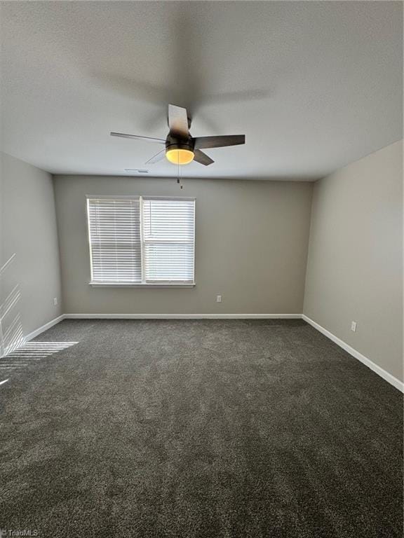 carpeted empty room with a textured ceiling and ceiling fan