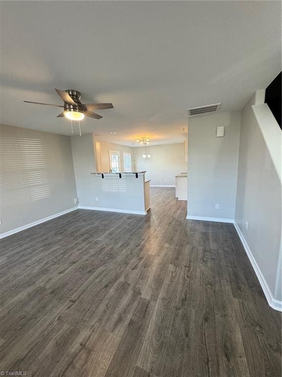 unfurnished living room with ceiling fan and dark wood-type flooring