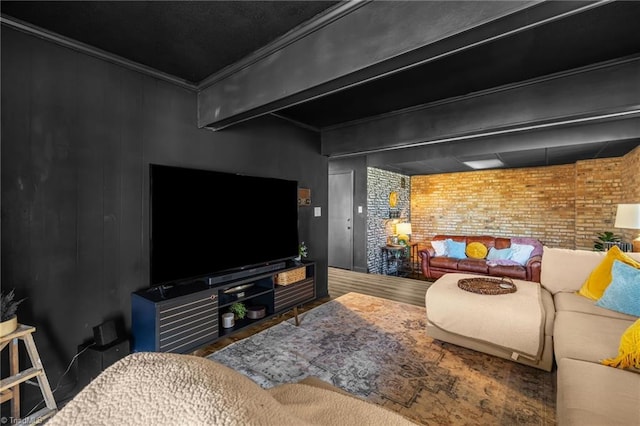 living room with beamed ceiling, wood finished floors, brick wall, and ornamental molding