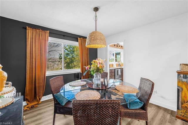 dining area with wood finished floors and baseboards