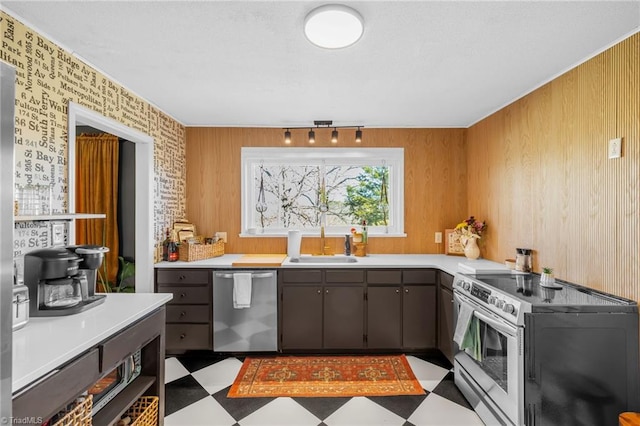 kitchen with light floors, stainless steel appliances, light countertops, and a sink