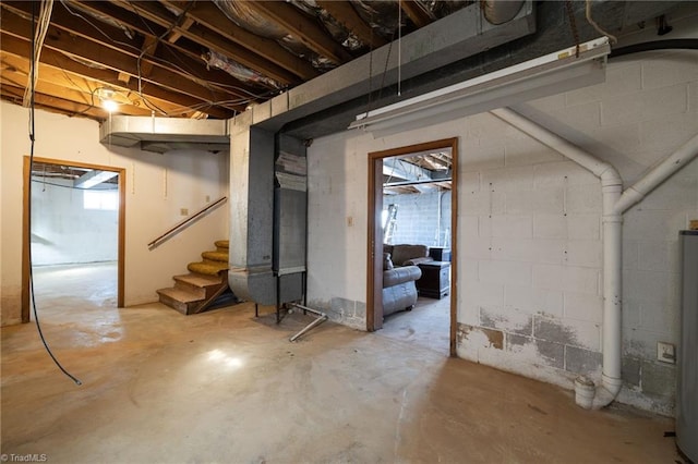 basement with water heater and stairway