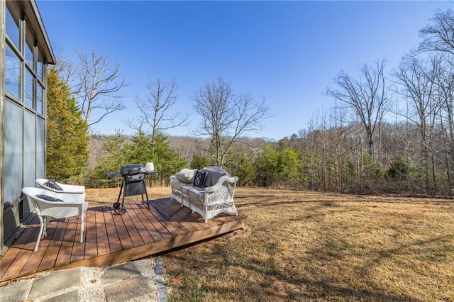 exterior space with a deck and a wooded view