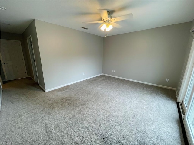 spare room with ceiling fan and carpet floors