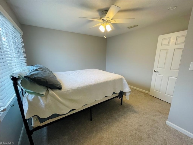 bedroom featuring light carpet and ceiling fan