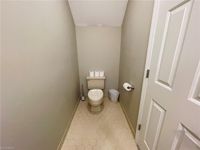 bathroom featuring tile patterned flooring and toilet