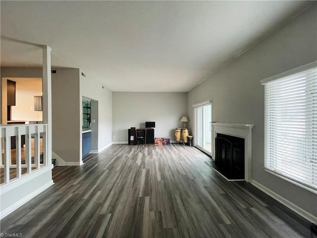 unfurnished living room with dark hardwood / wood-style flooring