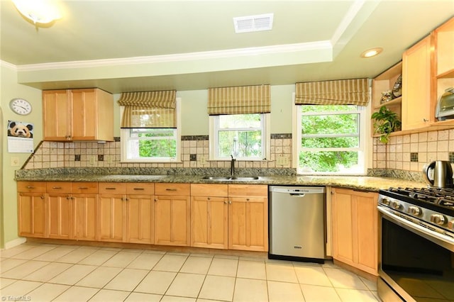 kitchen with visible vents, a sink, ornamental molding, stainless steel appliances, and backsplash