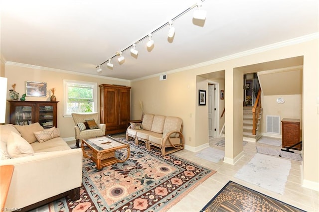 living room featuring visible vents, ornamental molding, and stairs