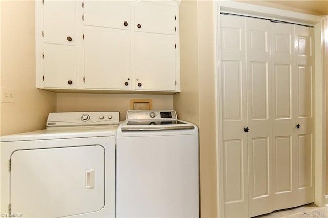 laundry area featuring cabinet space and washing machine and clothes dryer