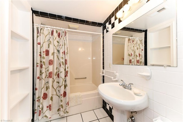 full bathroom featuring tile patterned floors, visible vents, shower / tub combo with curtain, tasteful backsplash, and tile walls